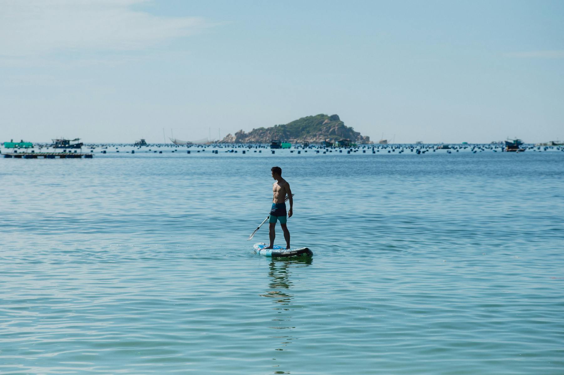 Beginner paddling on calm sea water